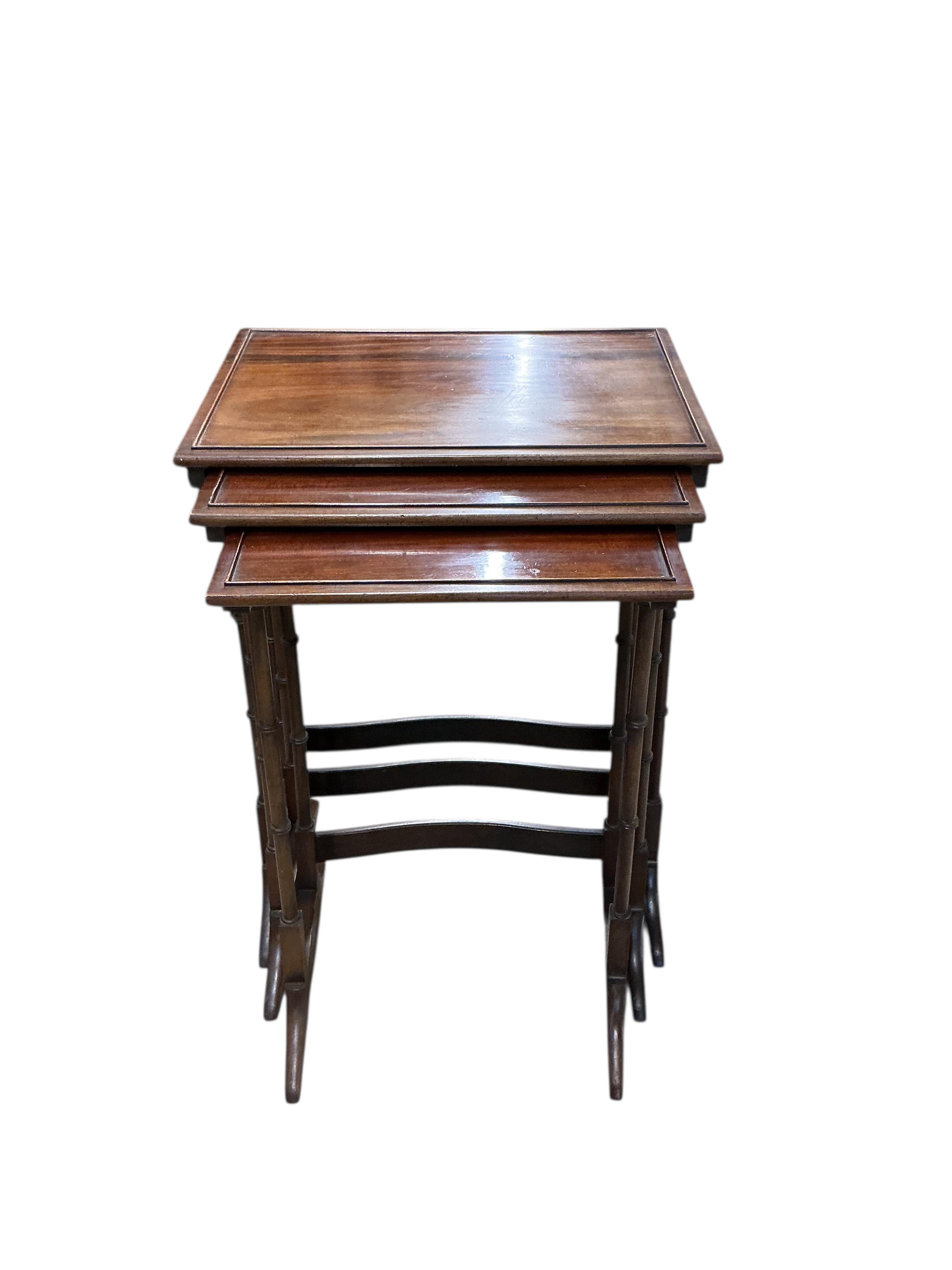 A nest of three Edwardian rectangular mahogany tea tables, width 50cm, depth 35cm, height 71cm